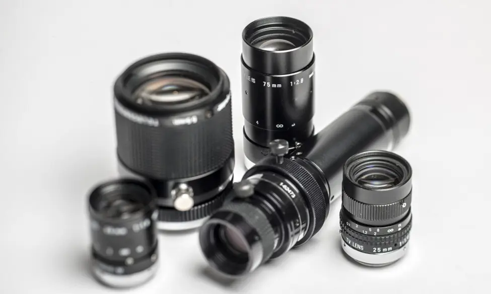 Various focal length machine vision camera lenses displayed on a white background, illustrating optical components for industrial imaging systems.